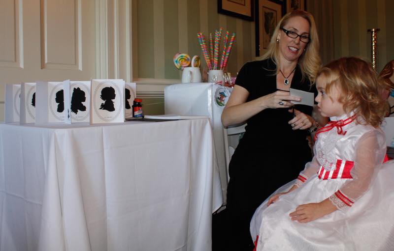 Kathryn Flocken cutting a silhouette at a birthday party